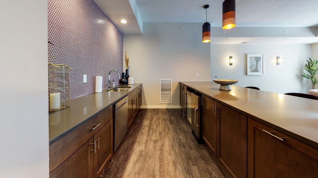 a kitchen with a long counter and wooden cabinets at The Morrison, Rosemount