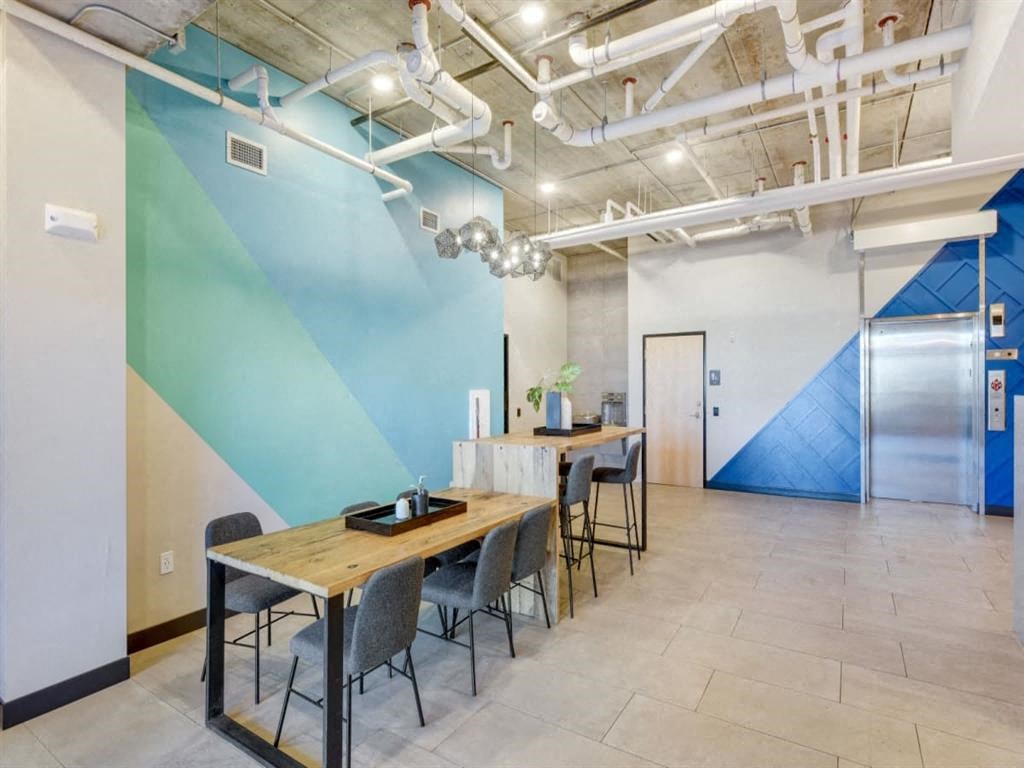 A room with a table and chairs and a blue wall.