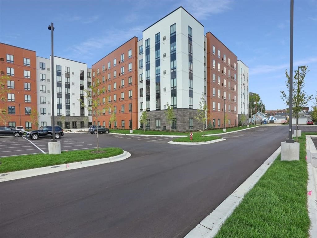 A street view of a residential area with apartment buildings.