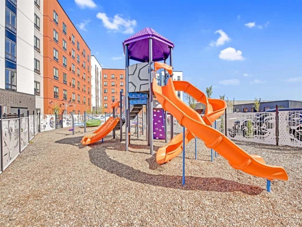 A playground with a purple and orange slide.
