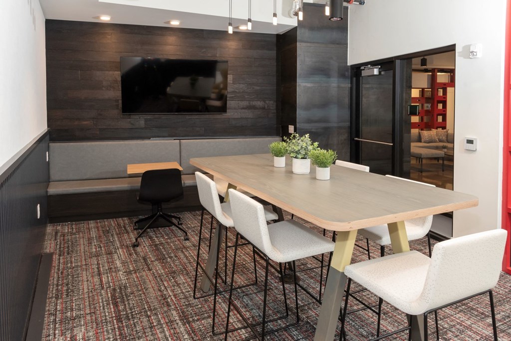 a dining room with a table and chairs and a tv