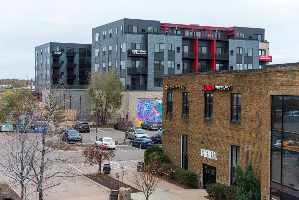 an aerial view of a city street with a building and other buildings