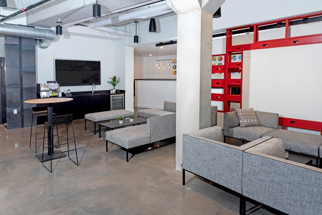 a living room with couches and a table and a kitchen