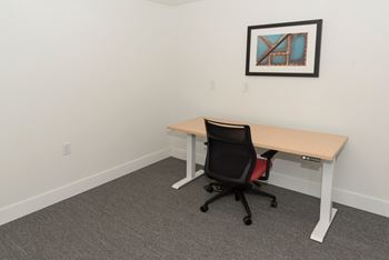 an empty office with a desk and a chair