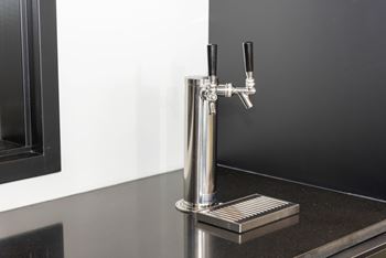 a close up of a kitchen tap on a counter top