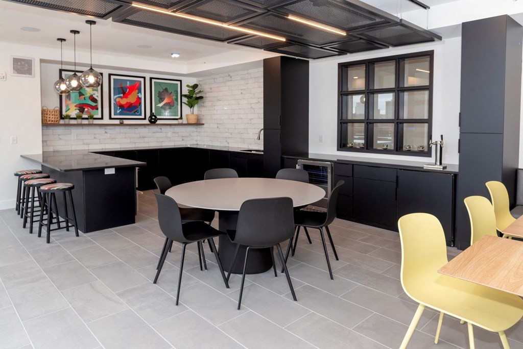 a dining room and kitchen with yellow chairs and a table