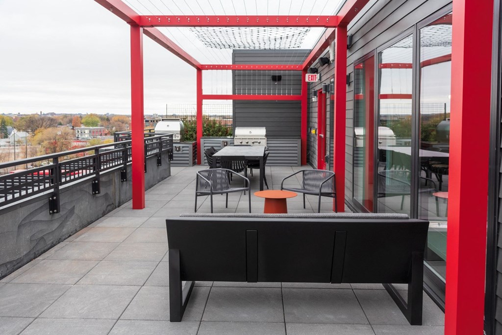 a terrace with tables and chairs on a roof