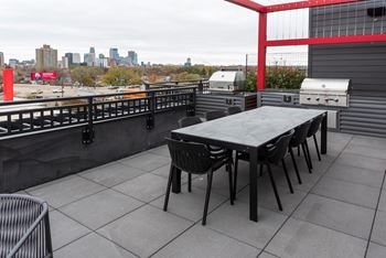 a patio with a table and chairs on a roof