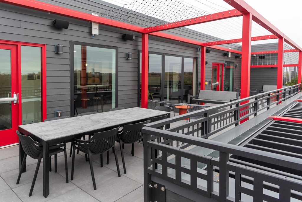 a patio with tables and chairs outside of a building