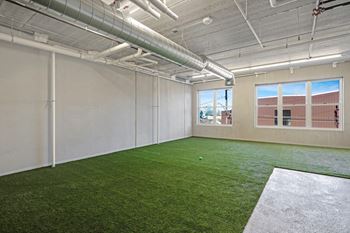 the interior of an office with green turf on the floor
