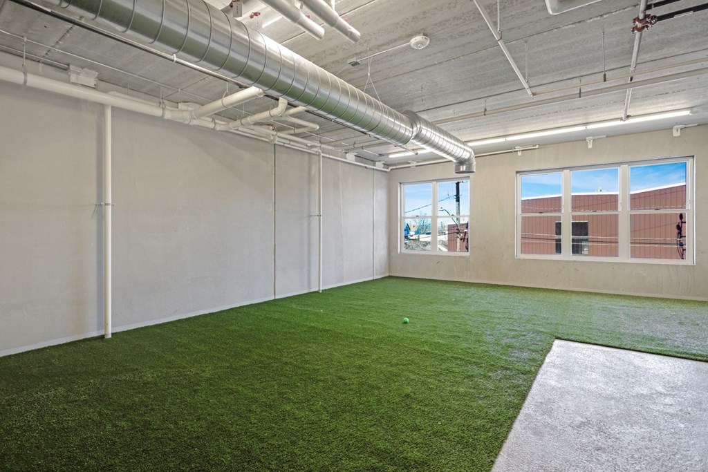 the interior of an office with green turf on the floor