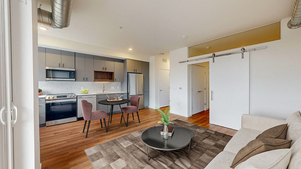 A modern kitchen with a dining table and chairs.