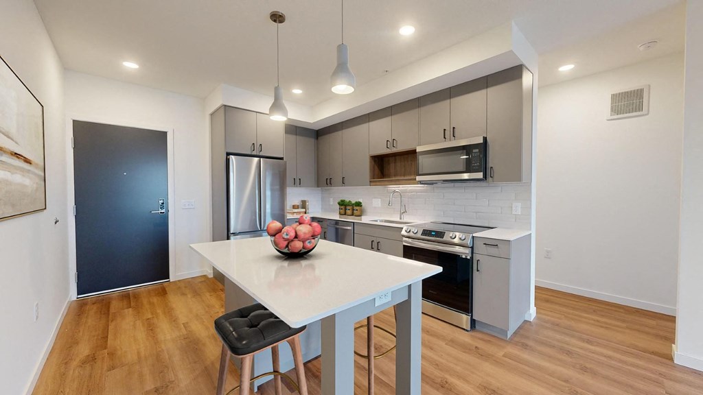 A modern kitchen with a dining table and chairs.