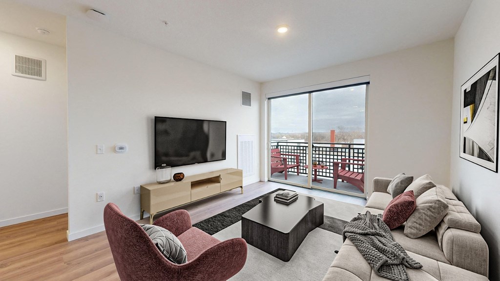 A living room with a red chair and a television.