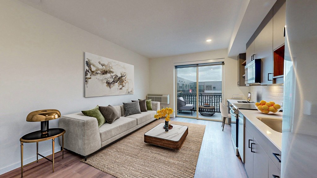 A modern living room with a grey couch and a coffee table.