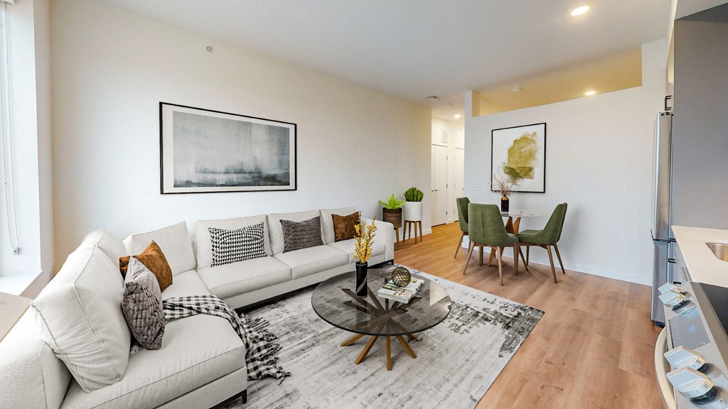 A living room with a white couch and a coffee table.