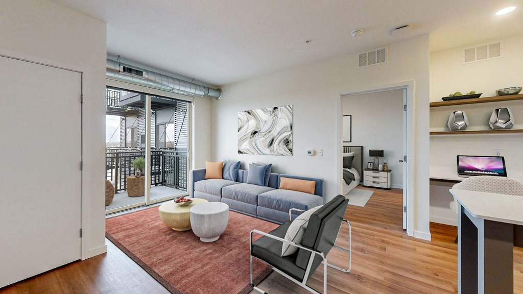A modern living room with a blue couch and a white chair.