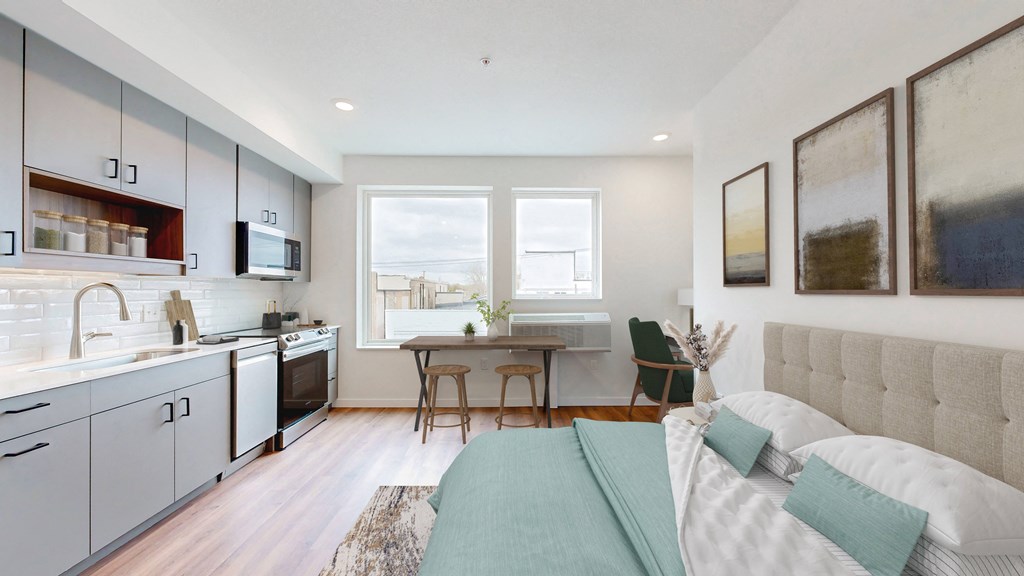 a living room and kitchen with a couch and a table