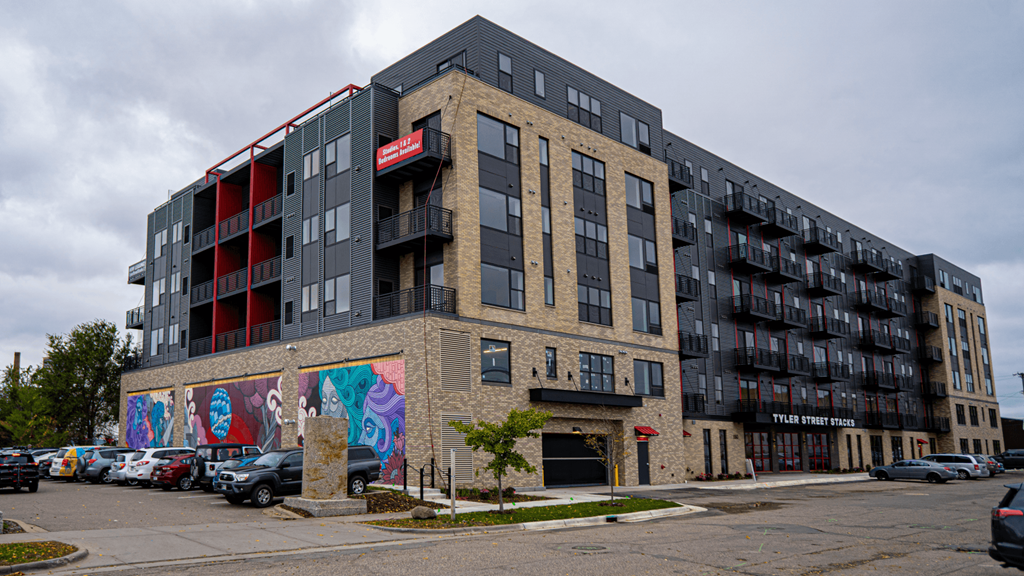 a large apartment building with graffiti on the side of it