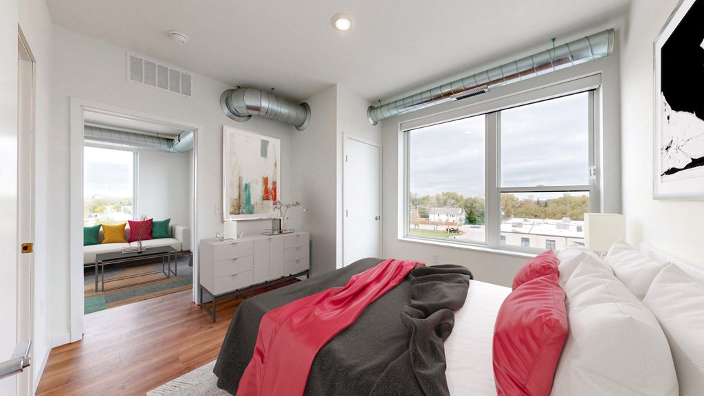 a bedroom with a bed and a large window