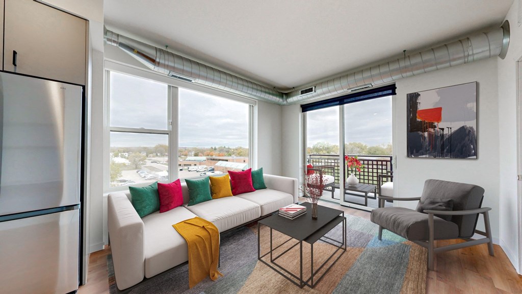 an open living room with a white couch and a table with colorful pillows