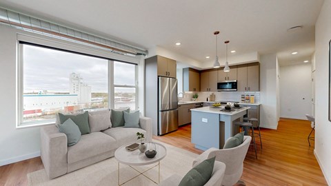 a living room and kitchen with a couch and a table