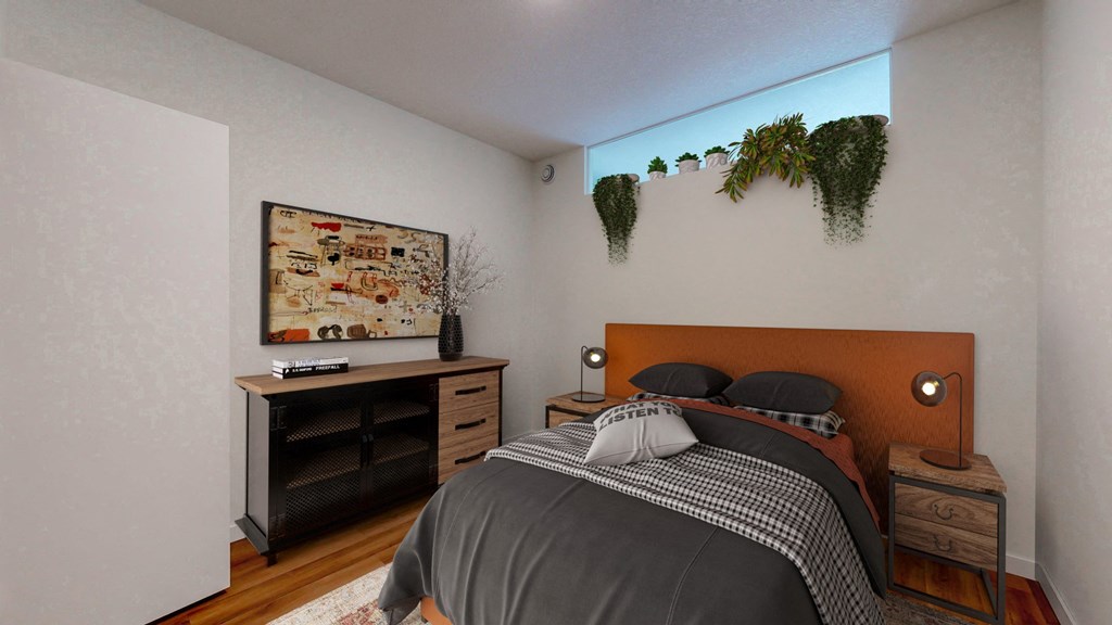 a bedroom with a bed and a window with plants on the wall
