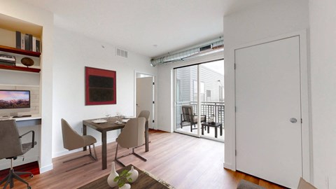 a dining room with a table and chairs and a sliding glass door to a balcony