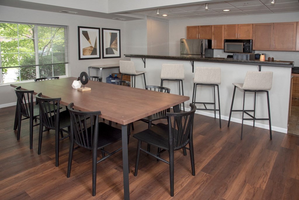 UPI community room with table seating and kitchen at Urban Park I and II Apartments, Minnesota
