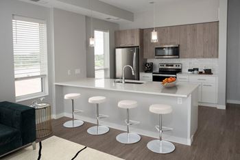 kitchen with seating at bar area at Urban Park I and II Apartments, St Louis Park