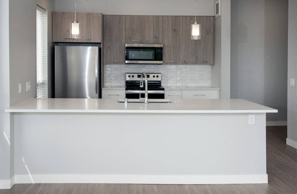 Joel floor plan, beautiful finishes, quartz countertops, modern backsplash at Urban Park I and II Apartments, St Louis Park, MN