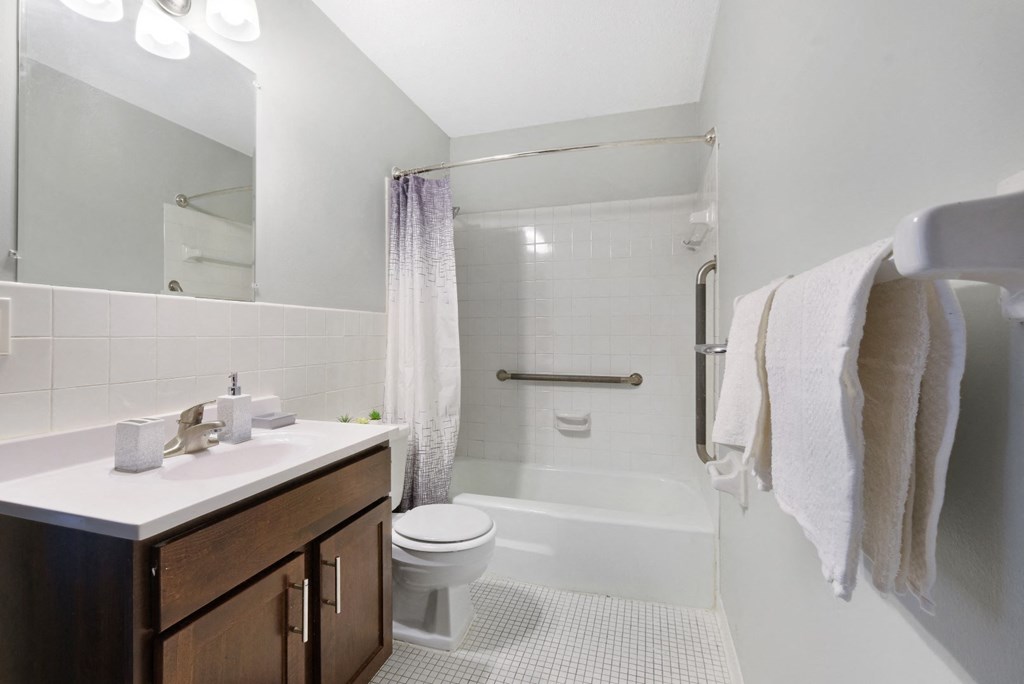 a bathroom with a toilet sink and bathtub in a 555 waverly unit