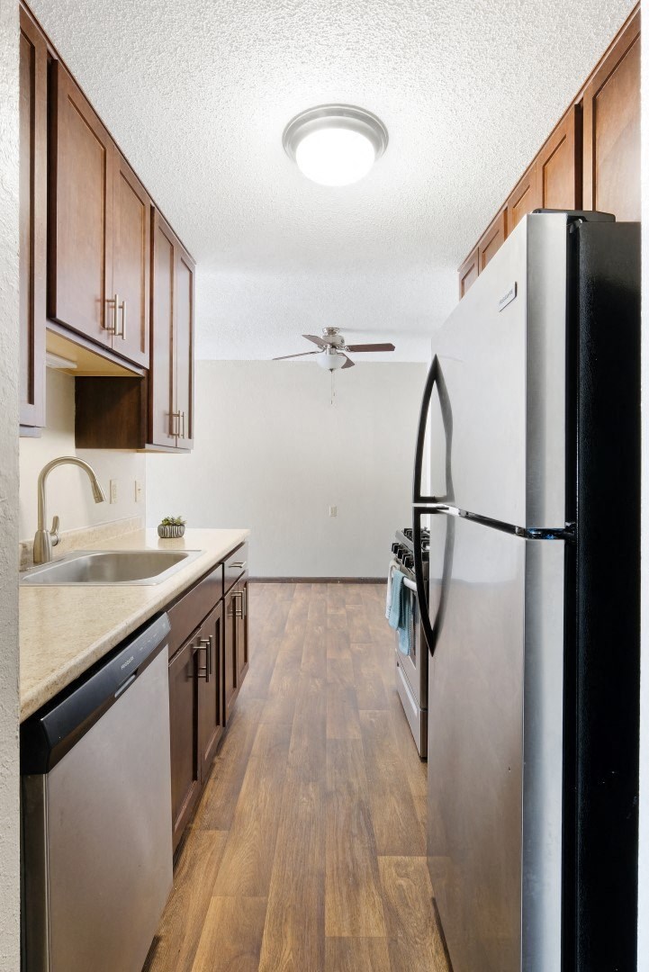 a kitchen with white appliances and wooden cabinets