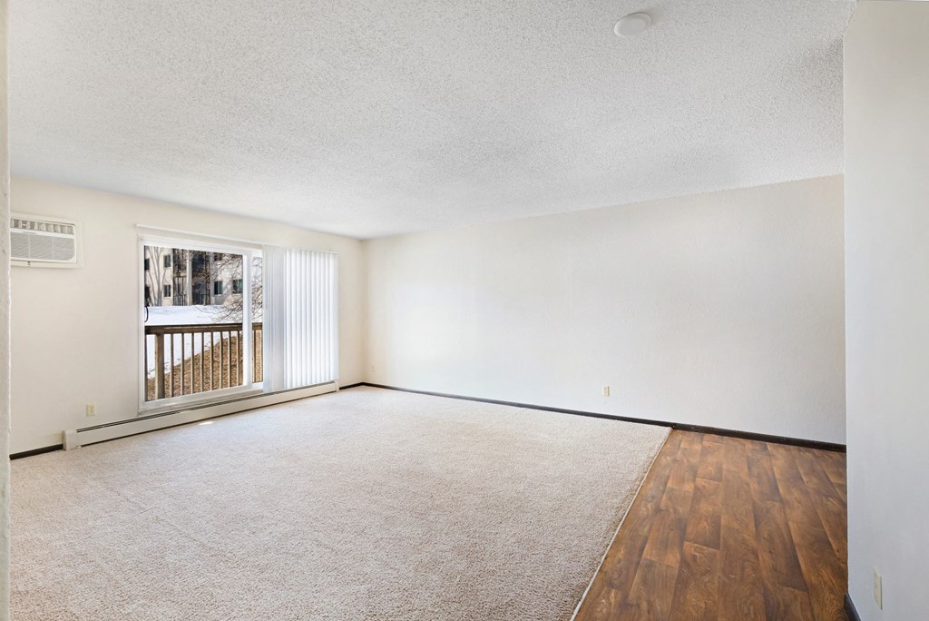 a bedroom with hardwood floors and white walls