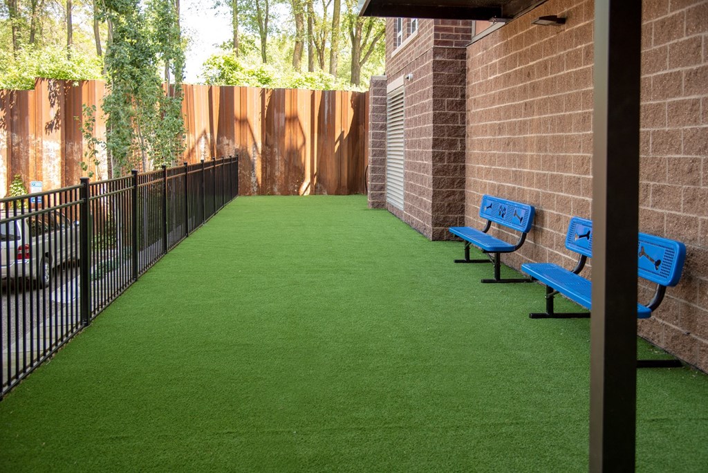 Outdoor dog run with artificial turf and benches at Victoria Flat, Victoria, MN