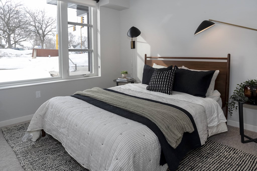 a bedroom with a bed and a window