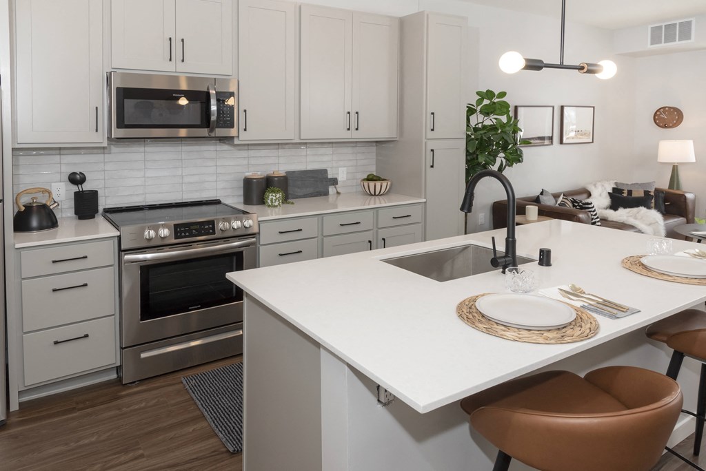 a kitchen with white cabinets and stainless steel appliances