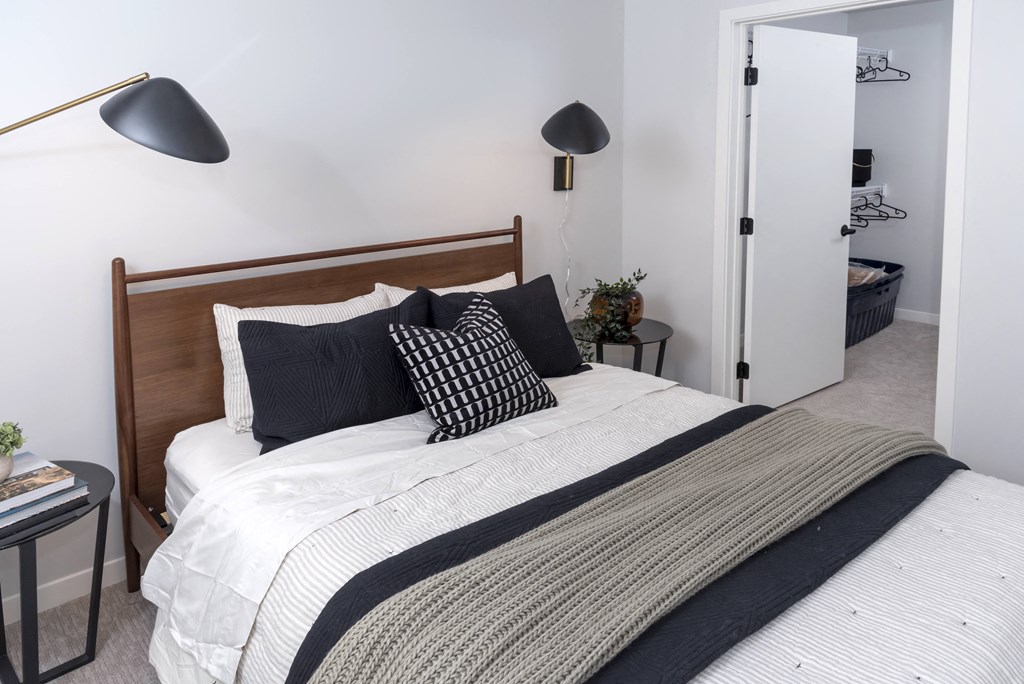 a bedroom with a bed and two lamps