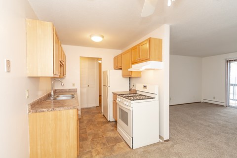A kitchen with a white refrigerator and a white oven.