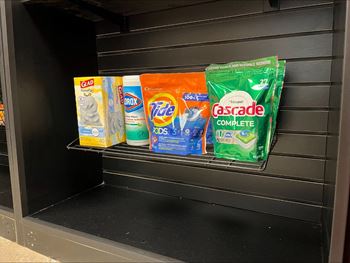 A display of laundry detergent and fabric softener.