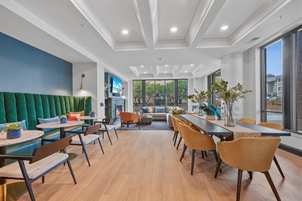 a lounge area with tables and chairs and a fireplace