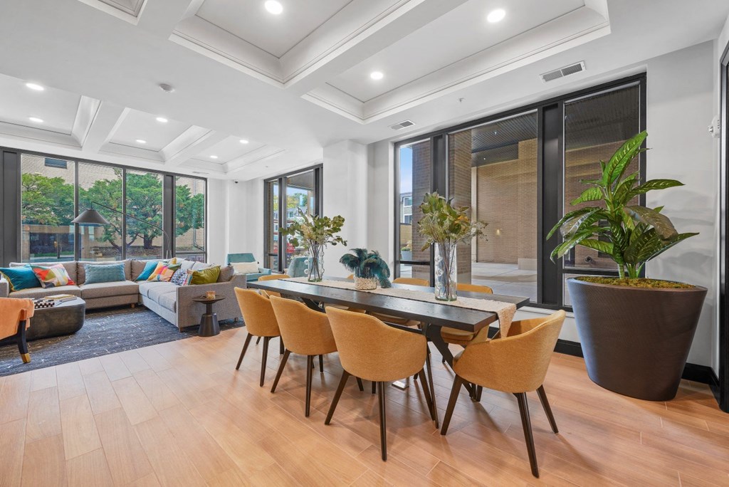 a dining area with a table and chairs and a living room with a couch