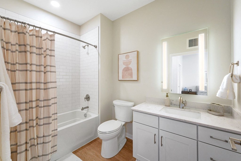 a white bathroom with a shower toilet and sink