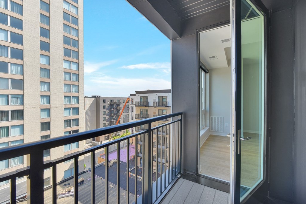 a balcony with a door and a view of the city