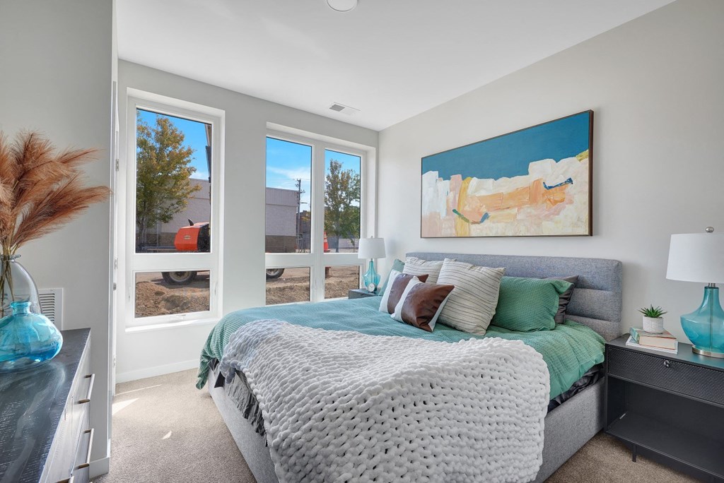 a bedroom with a large bed and a large window