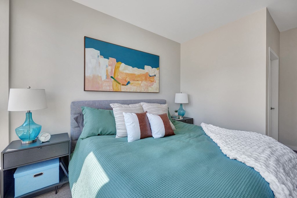 a bedroom with a large bed and two night stands with lamps