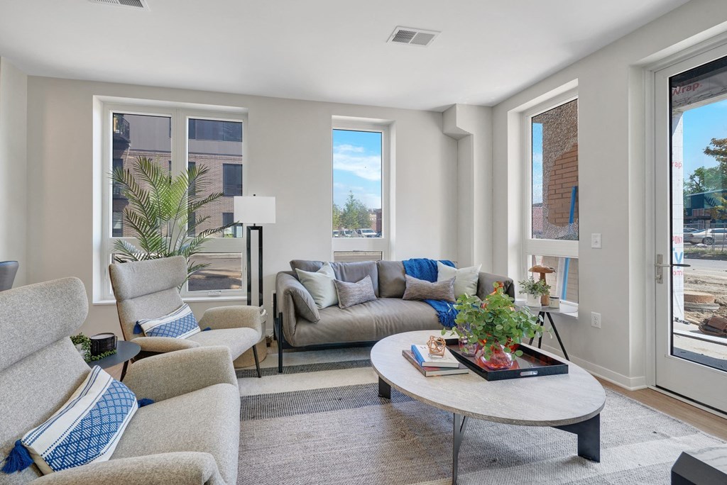 a living room with couches chairs and a coffee table