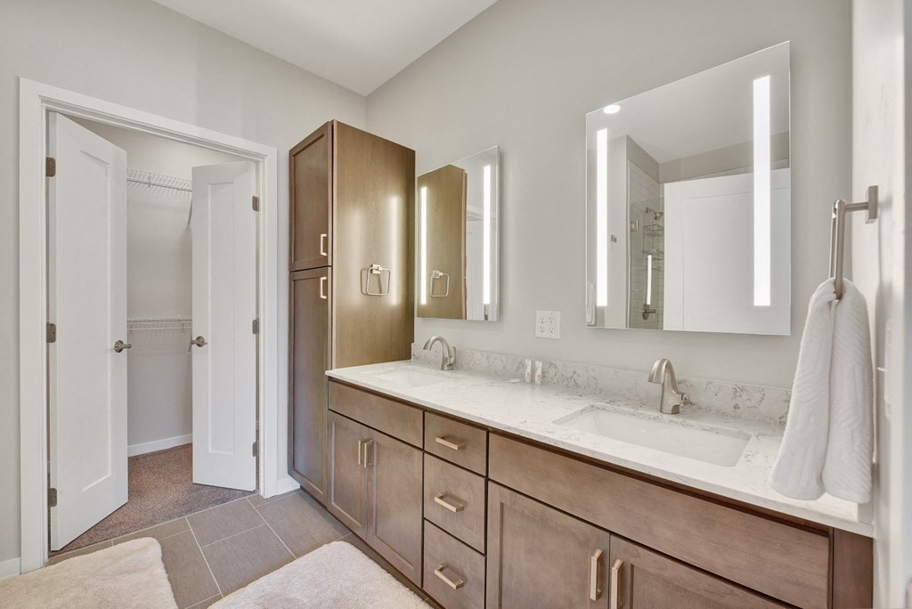 a bathroom with a large vanity with two sinks and two mirrors