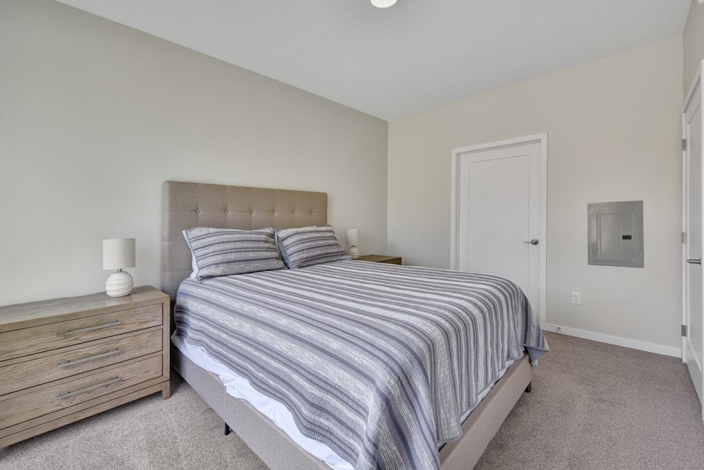 a bedroom with a bed and two night stands