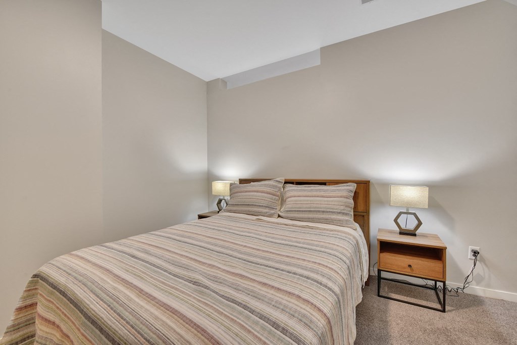 a bedroom with a bed and two night stands